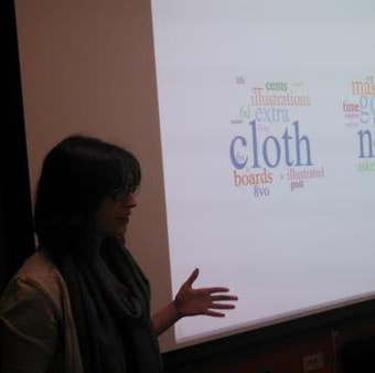 Beth Seltzer in front of topic modeling word clouds